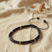 Zierliches Jaspis-Armband aus echten Natursteinperlen in Schwarz und Gold – inspiriert von den sieben Energiezentren, minimalistisch & handgefertigt.