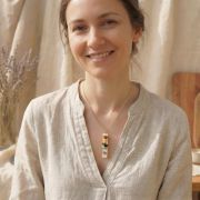 Frau trägt einen Chakra Selenit Anhänger mit Natursteinen, ideal für Meditation und Yoga.