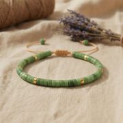 Detailaufnahme des Serpentin Armbands mit grünen Flachperlen und goldenen Akzenten